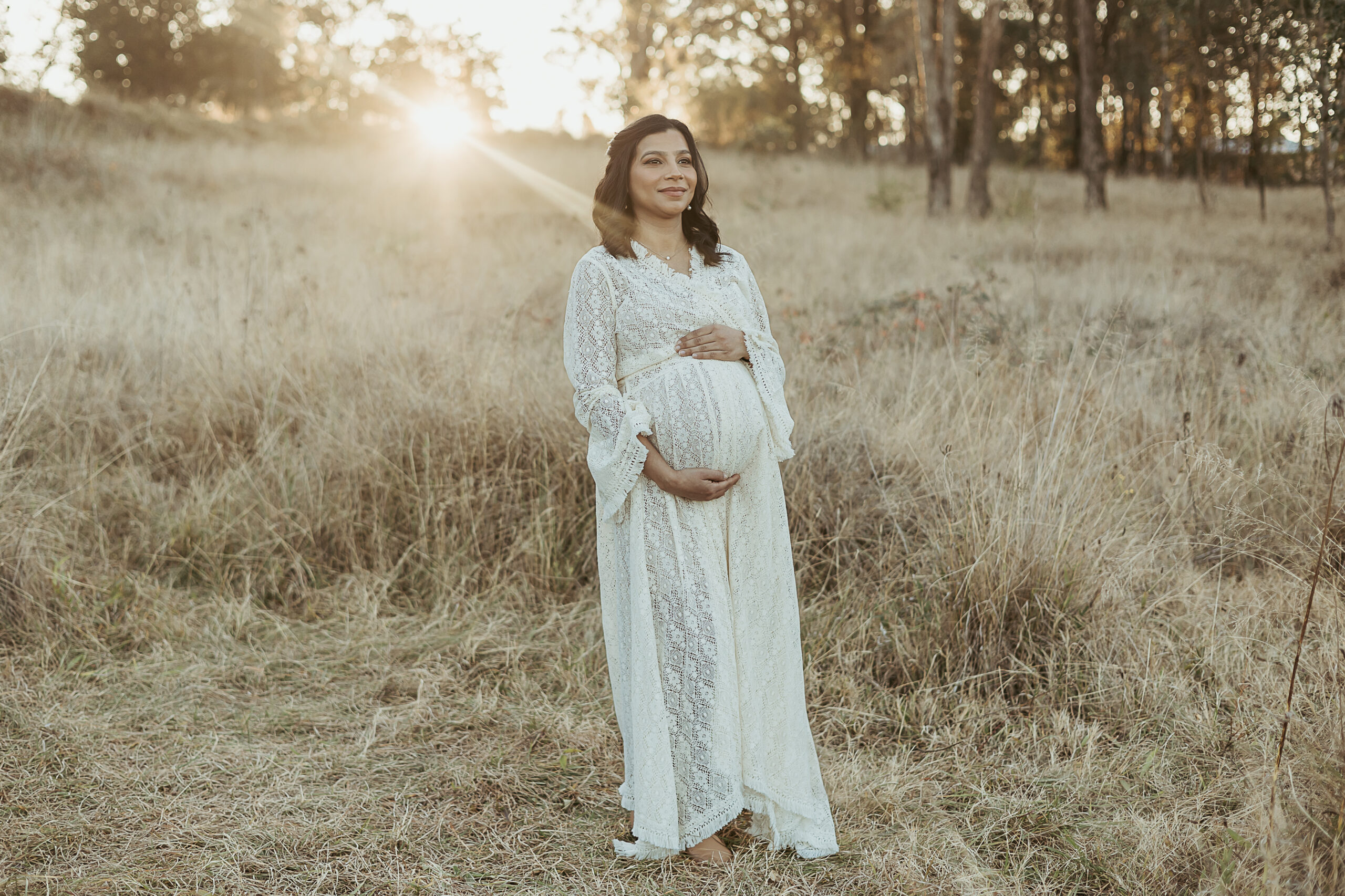 Beautiful pregnant mum-to-be wearing a gorgeous lace robe for a sunset maternity photoshoot in Sydney.